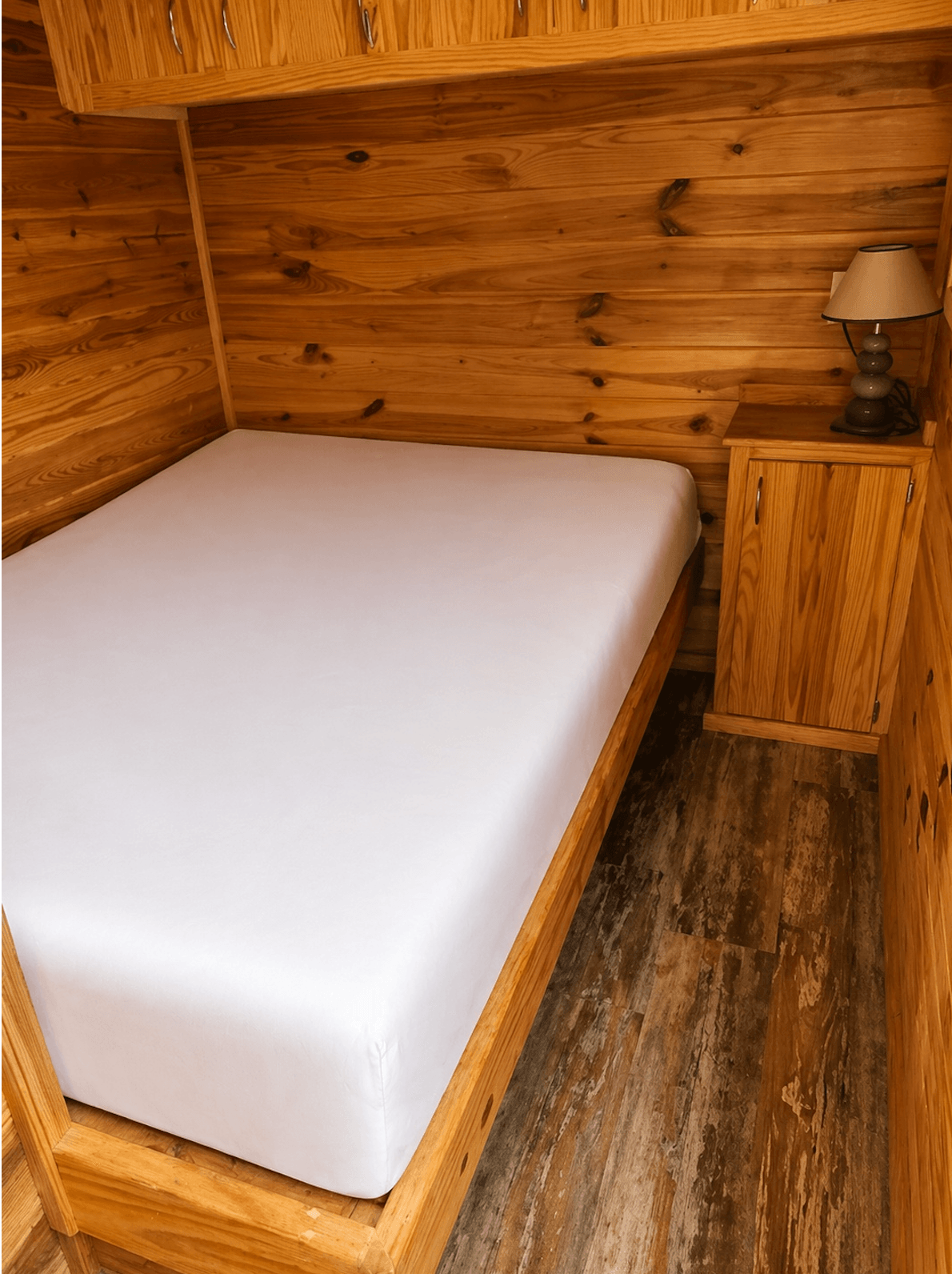 A made-up cabin bed with fresh linens at Country Acres